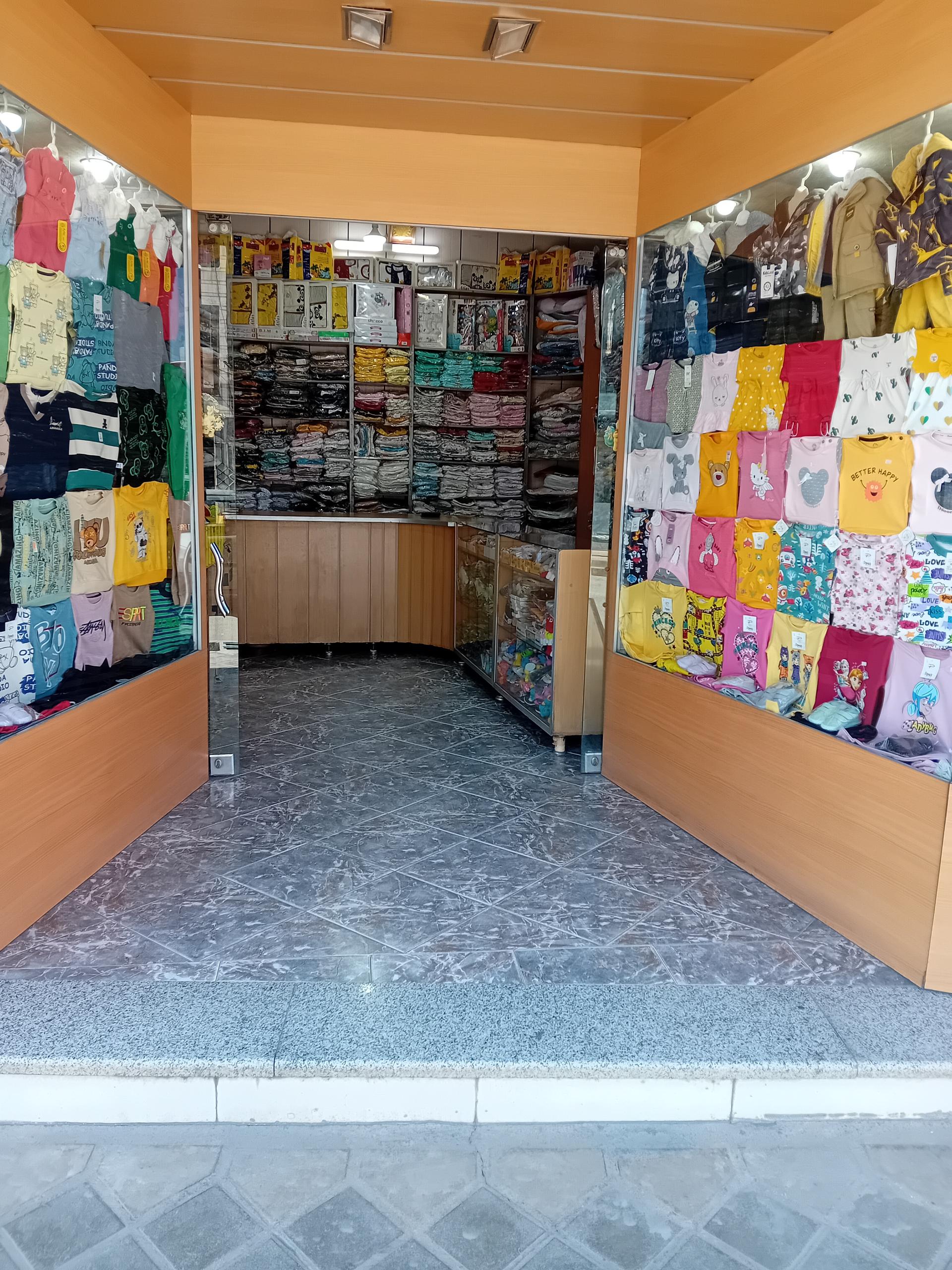 عکس دنیای کودک سیسمونی و پوشاک بچه