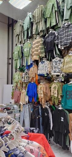 عکس فروشگاه لباس دنیای کودک